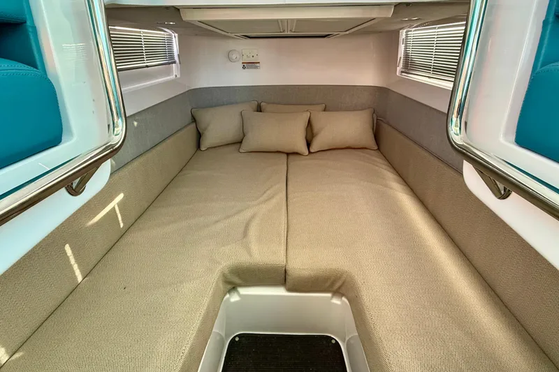 Slide: The Image of 2021 Axopar 37 XC CROSS CABIN interior with beige cushions and modern design. - 20
