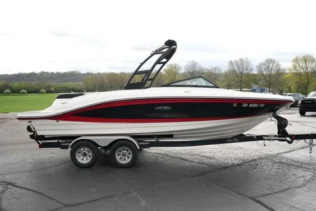 Slide: The Image of 2022 Sea Ray SPX 210 boat on trailer, parked outdoors. - 14