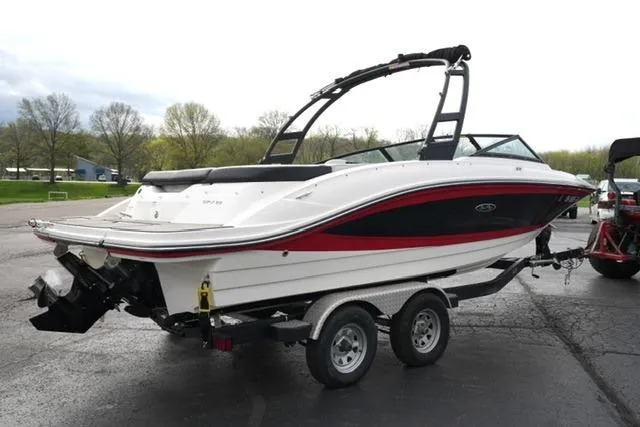 Slide: The Image of 2022 Sea Ray SPX 210 boat on trailer, parked outdoors. - 15