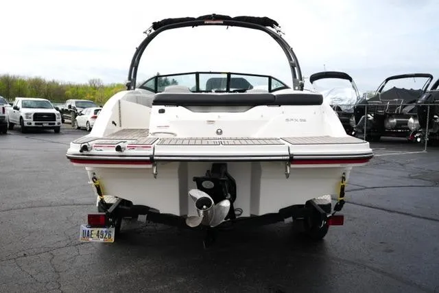 Slide: The Image of 2022 Sea Ray SPX 210 boat, rear view, parked in a lot. - 16
