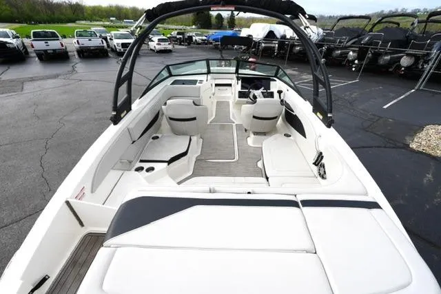 Slide: The Image of 2022 Sea Ray SPX 210 boat interior with white seating and modern design. - 18