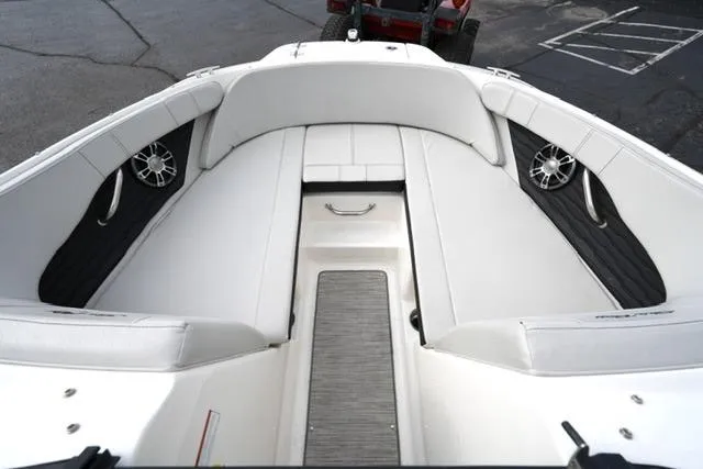 Slide: The Image of 2022 Sea Ray SPX 210 boat interior with white seating and speakers. - 19