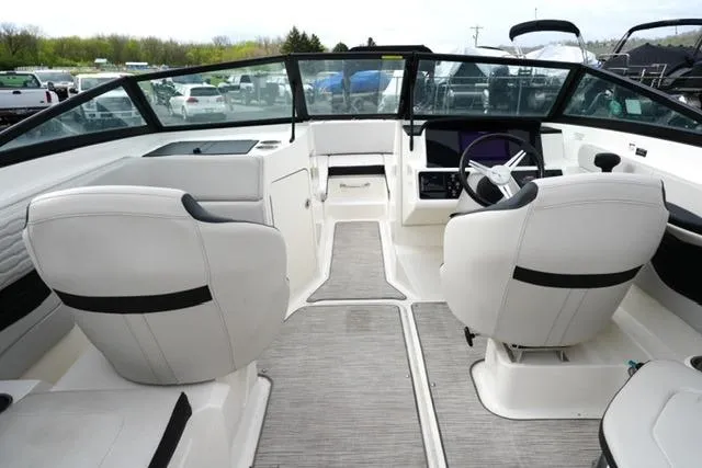 Slide: The Image of 2022 Sea Ray SPX 210 boat interior with modern seating and sleek dashboard design. - 21