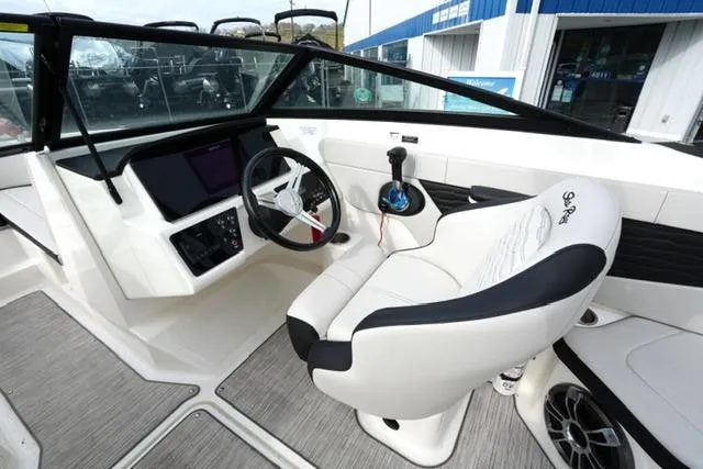 Slide: The Image of 2022 Sea Ray SPX 210 boat interior with modern steering and controls. - 22