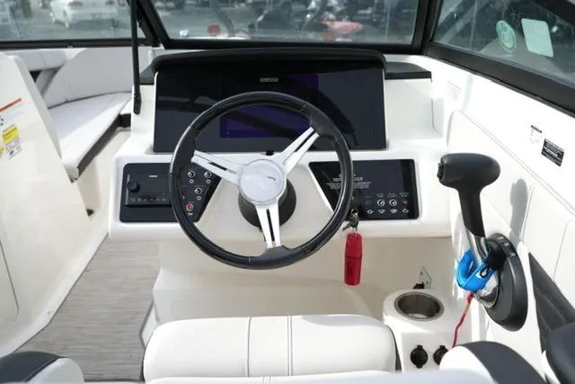 Slide: The Image of 2022 Sea Ray SPX 210 boat dashboard with steering wheel and control panel. - 23