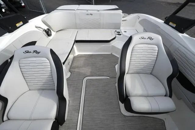 Slide: The Image of 2022 Sea Ray SPX 210 boat interior with white seating and modern design. - 24