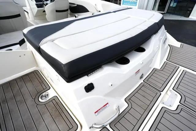 Slide: The Image of 2022 Sea Ray SPX 210 boat interior with cushioned seating and sleek deck design. - 25