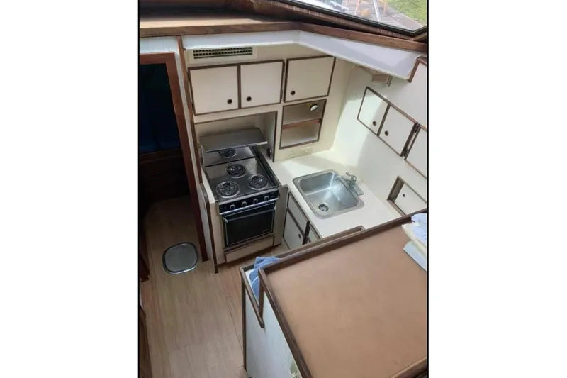 Slide: The Image of 1985 Hatteras 36 Convertible yacht kitchen with stove, sink, and cabinets. - 3