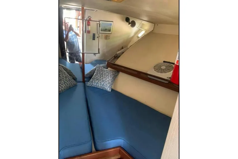 Slide: The Image of Interior of 1985 Hatteras 36 Convertible with blue seating and decorative pillows. - 4