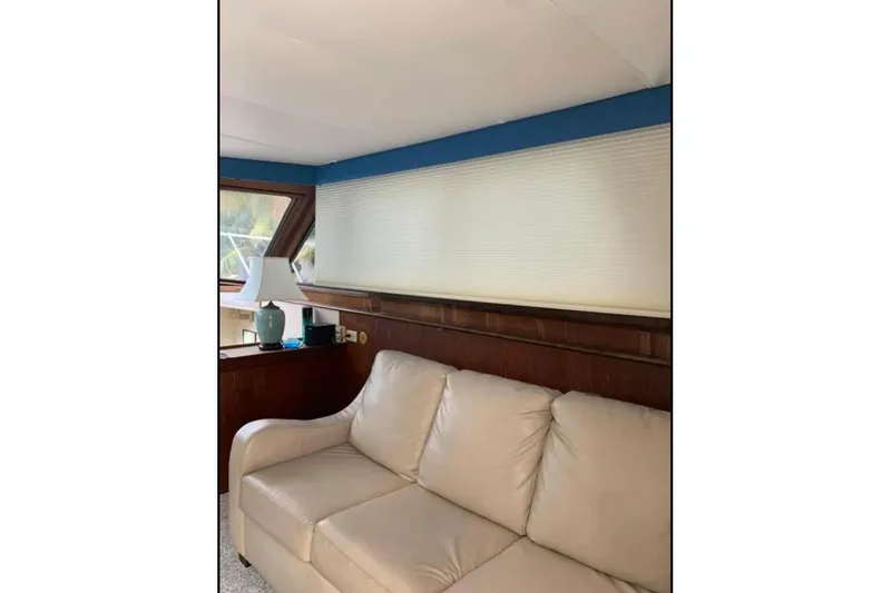 Slide: The Image of Interior of 1985 Hatteras 36 Convertible yacht with beige sofa and lamp. - 6