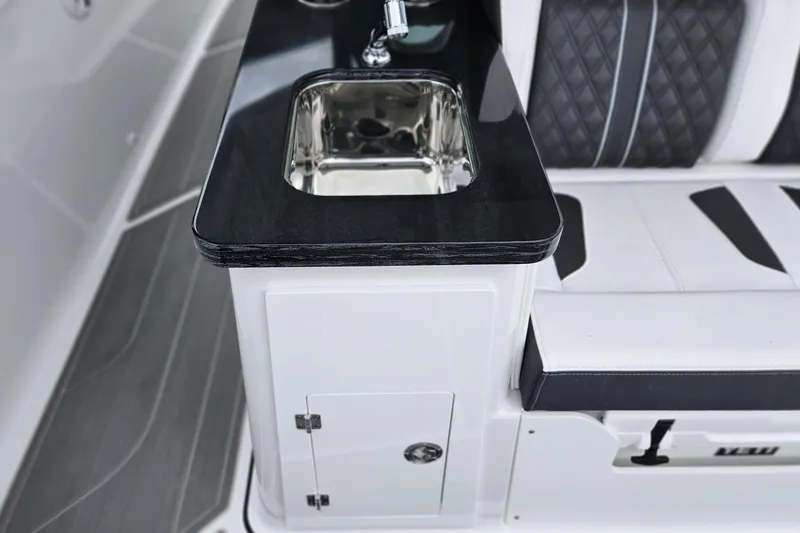 Slide: The Image of Luxury interior of 2026 Monterey Elite 30 OB boat with sleek sink and seating. - 10