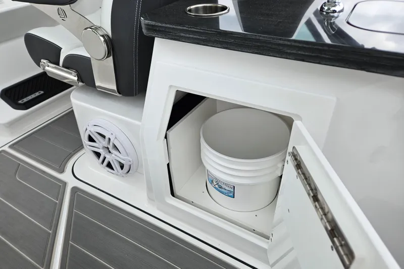 Slide: The Image of 2026 Monterey Elite 30 OB boat interior with storage compartment and bucket. - 13