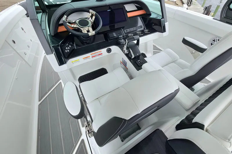Slide: The Image of 2026 Monterey Elite 30 OB boat interior with modern helm and luxurious seating. - 15