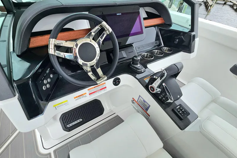 Slide: The Image of 2026 Monterey Elite 30 OB boat dashboard with modern steering and controls. - 16