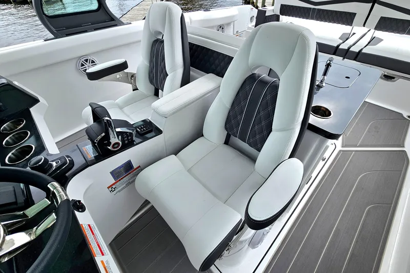Slide: The Image of Luxury interior of 2026 Monterey Elite 30 OB boat with plush seating and modern controls. - 17