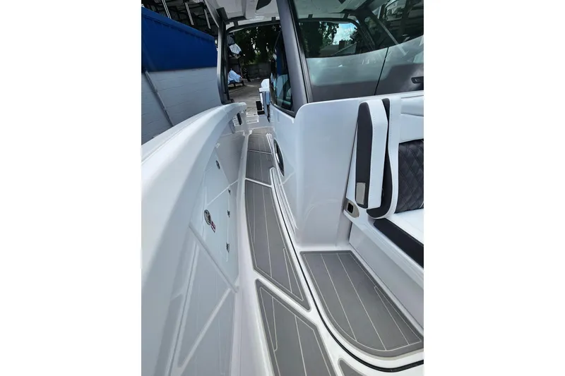 Slide: The Image of 2026 Monterey Elite 30 OB boat interior with sleek white and gray design. - 29