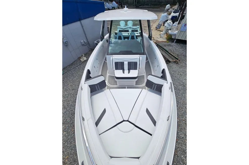 Slide: The Image of 2026 Monterey Elite 30 OB boat with sleek white design and spacious seating. - 34