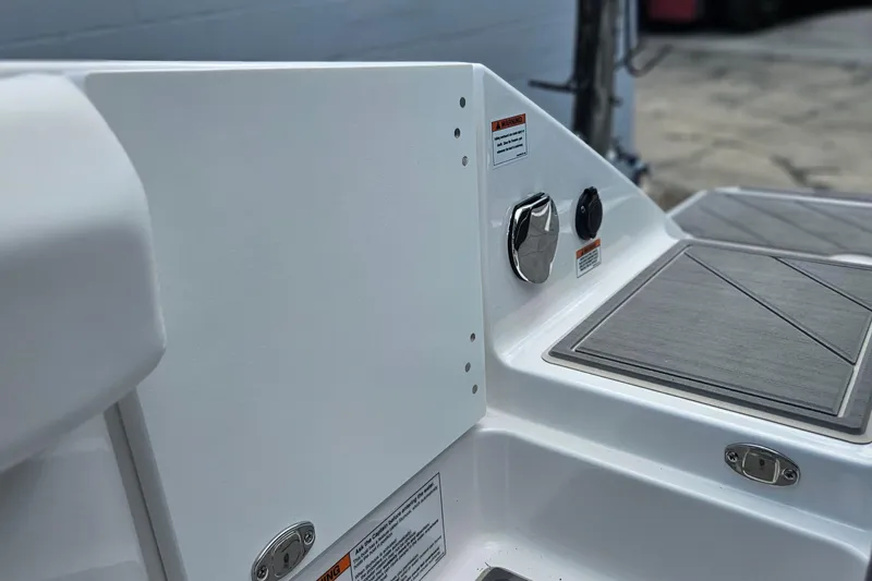 Slide: The Image of 2026 Monterey Elite 30 OB boat deck with control panel and warning labels. - 37