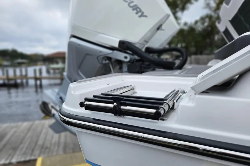 Slide: The Image of 2026 Monterey Elite 30 OB boat with Mercury outboard engine, docked by the water. - 39