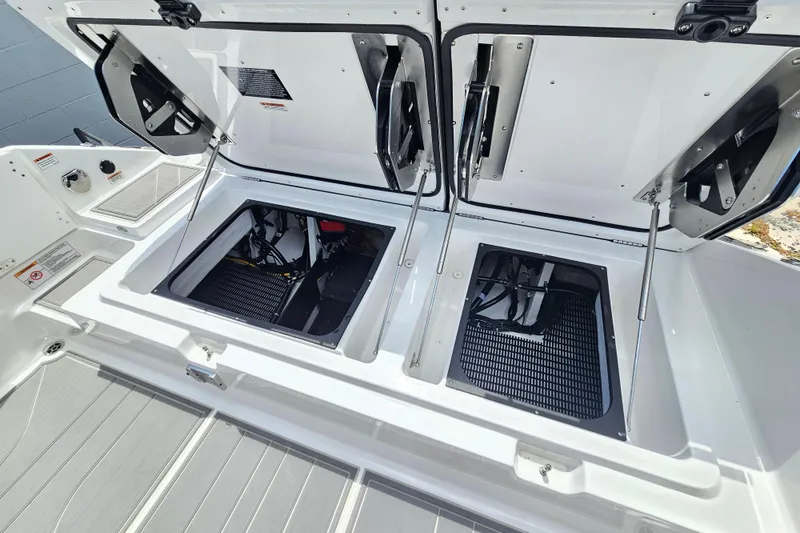 Slide: The Image of Open engine compartment of 2026 Monterey Elite 30 OB boat, showcasing storage and mechanical components. - 8