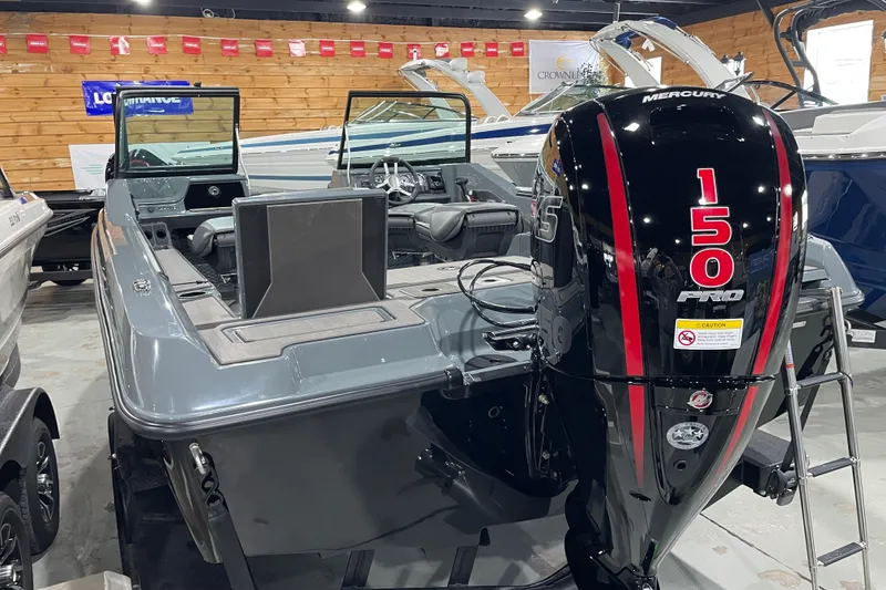 Slide: The Image of 2026 Lund 185 Impact GL boat with Mercury 150 Pro outboard motor in showroom. - 10
