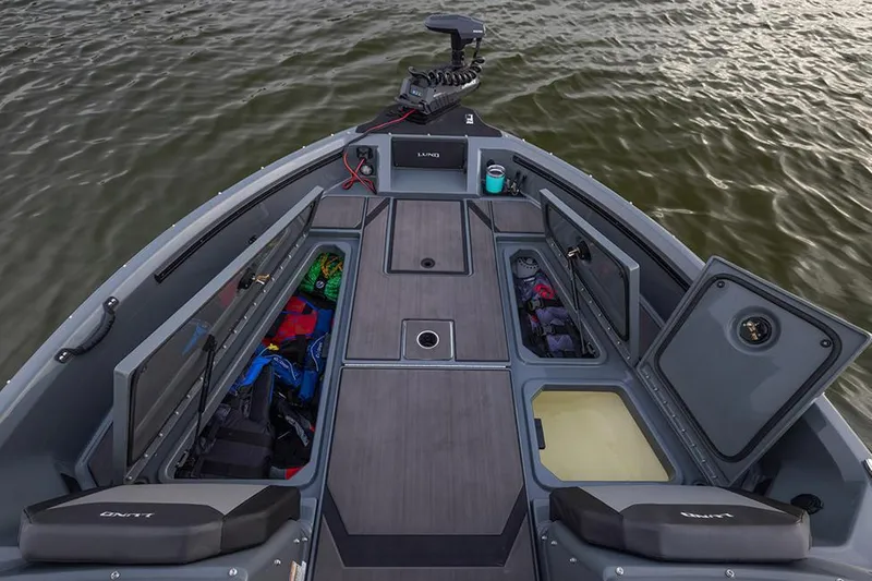 Slide: The Image of 2026 Lund 185 Impact GL boat interior with modern dashboard and seating. - 2