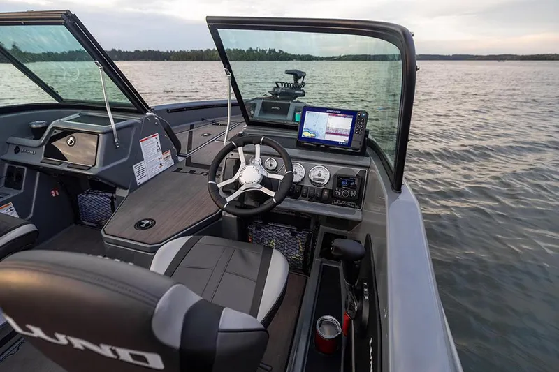 Slide: The Image of 2026 Lund 185 Impact GL boat interior with steering wheel and seating. - 4