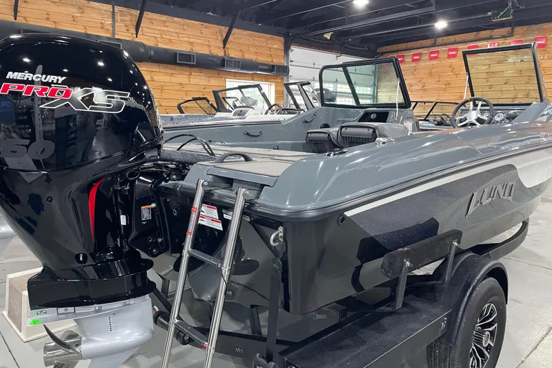 Slide: The Image of 2026 Lund 185 Impact GL boat with Mercury Pro XS engine in showroom. - 9