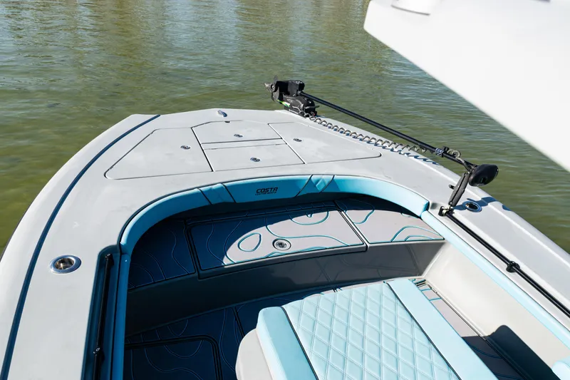 Slide: The Image of 2022 Costa Custom Boats 264, sleek deck design on calm water. - 17