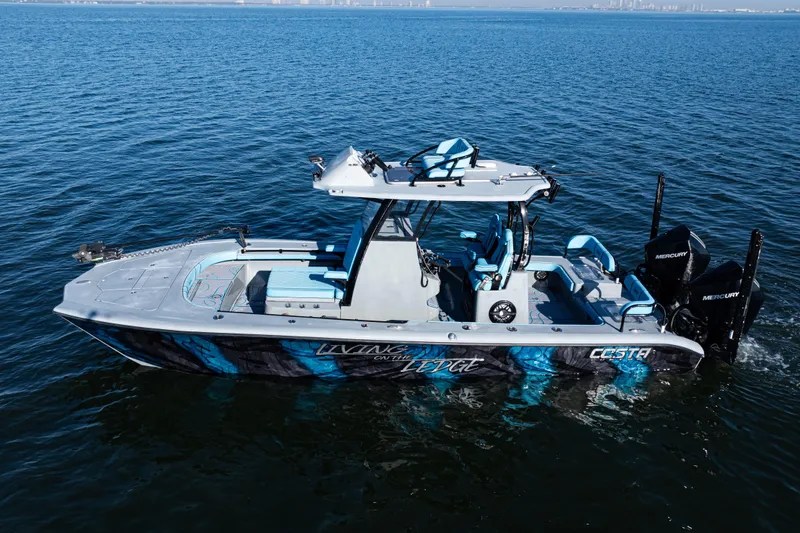 Slide: The Image of 2022 Costa Custom Boats 264 on open water, featuring sleek design and vibrant graphics. - 2