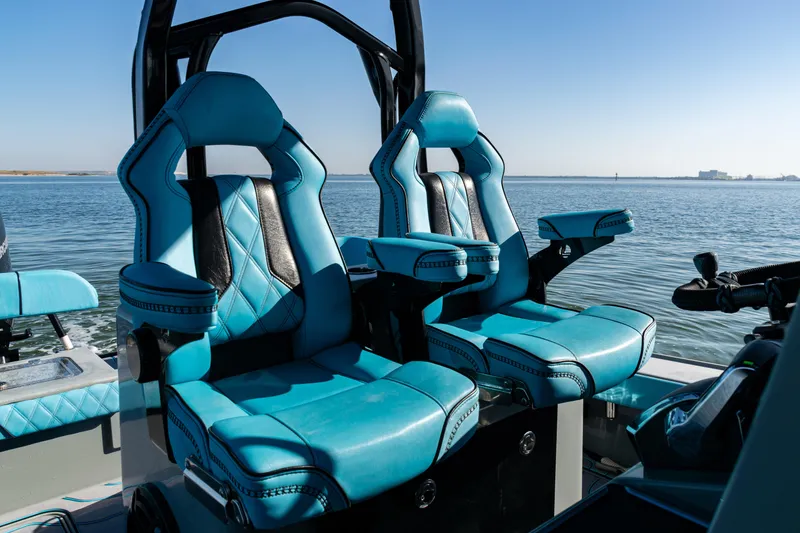 Slide: The Image of Luxurious blue seating on 2022 Costa Custom Boats 264, overlooking serene water. - 24