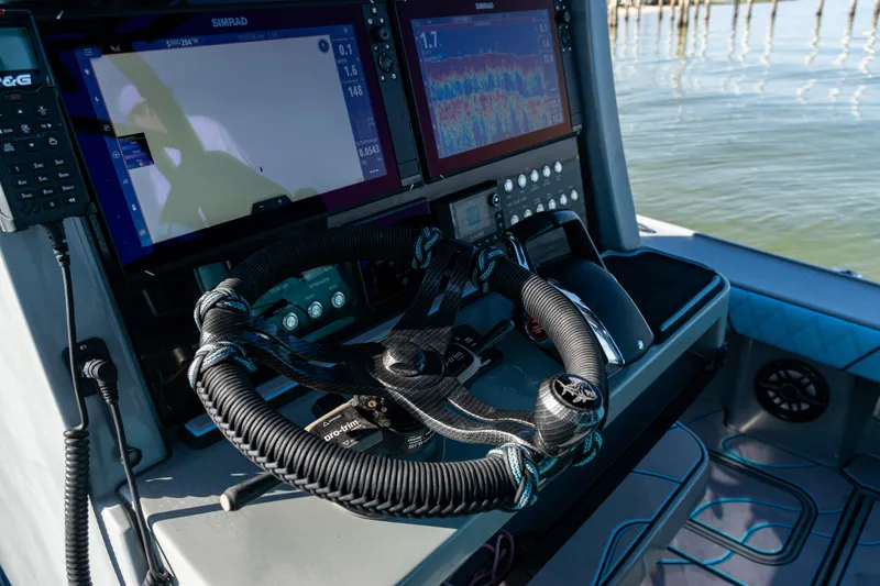 Slide: The Image of Steering console of 2022 Costa Custom Boats 264 with advanced navigation displays. - 26