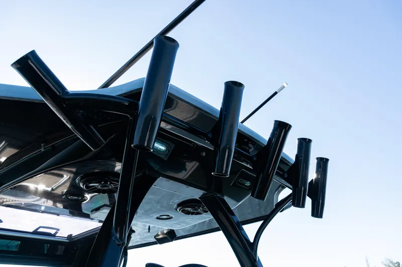 Slide: The Image of Rooftop rod holders on 2022 Costa Custom Boats 264 against clear sky. - 35