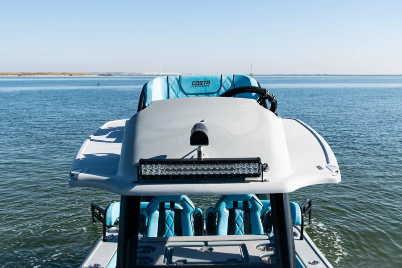 Slide: The Image of 2022 Costa Custom Boats 264 on water, featuring sleek design and modern seating. - 40