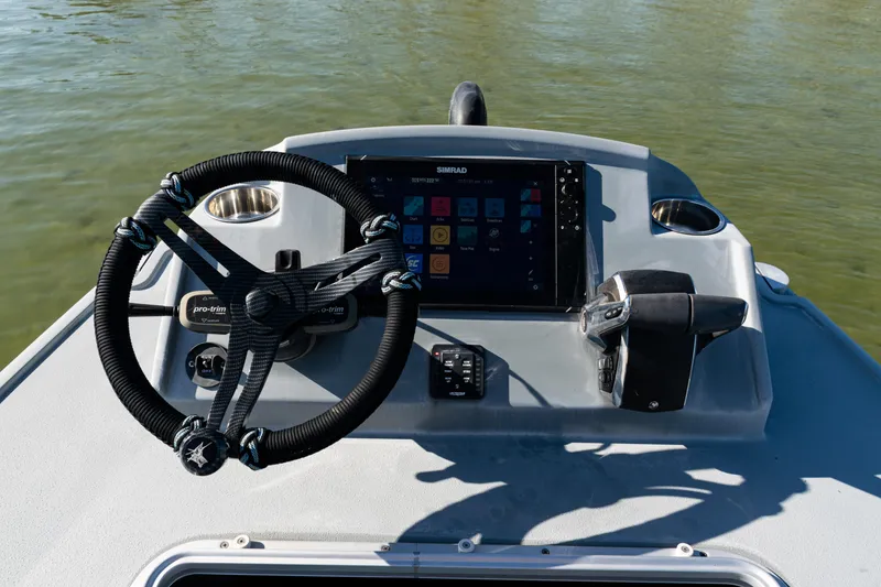Slide: The Image of Steering console of 2022 Costa Custom Boats 264 with navigation display and controls. - 43