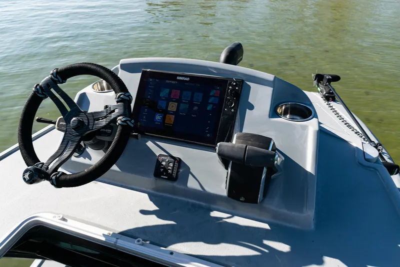 Slide: The Image of Helm of 2022 Costa Custom Boats 264 with steering wheel and navigation display. - 45