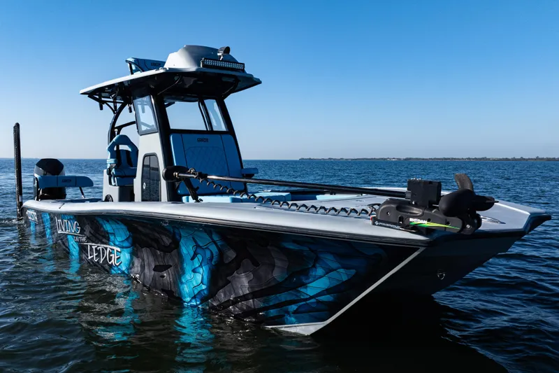 Slide: The Image of 2022 Costa Custom Boats 264 on water, featuring striking blue and black design. - 49