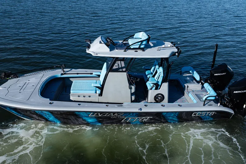 Slide: The Image of 2022 Costa Custom Boats 264 on water, featuring sleek design and vibrant blue accents. - 7