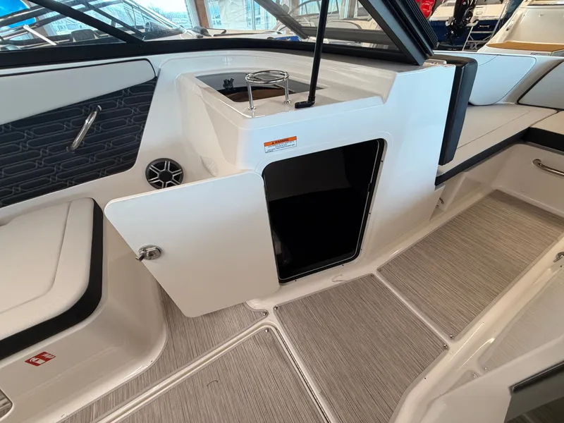Slide: The Image of Interior of 2026 Sea Ray SPX 210 with open storage compartment. - 21