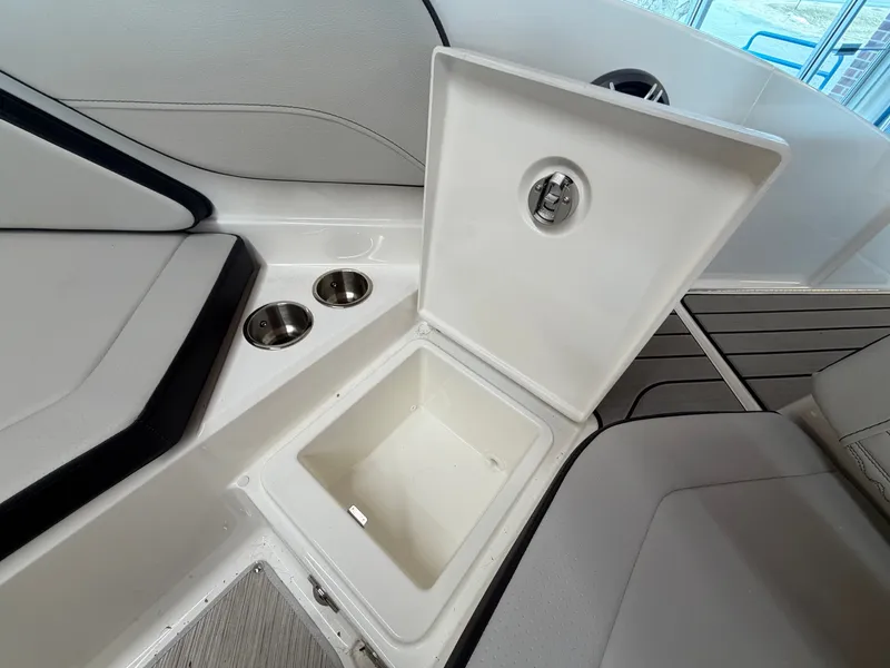 Slide: The Image of Interior of 2026 Sea Ray SPX 210 boat with storage compartment and cup holders. - 33