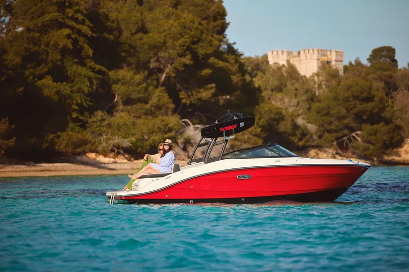 Slide: The Image of 2026 Sea Ray SPX 210 boat on blue water near wooded shoreline. - 37