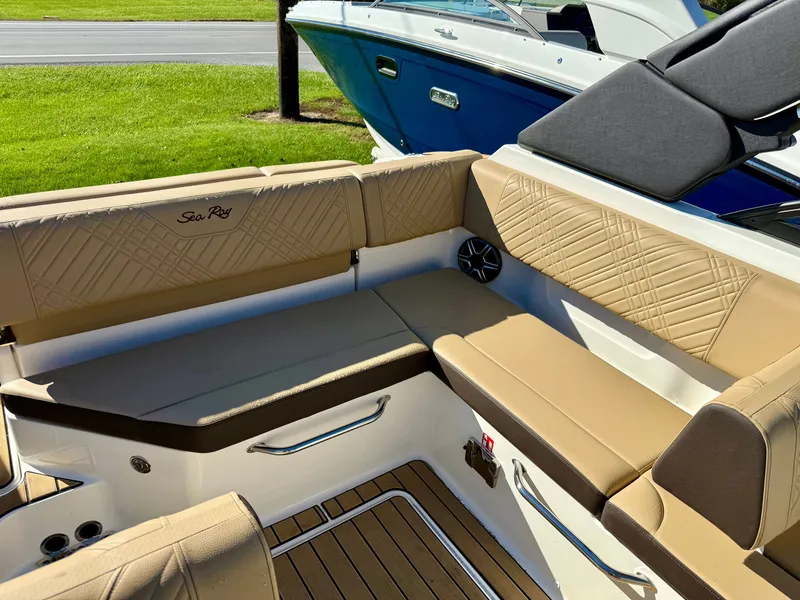 Slide: The Image of Interior of a Sea Ray SDX 230 with beige upholstery and wood flooring. - 9