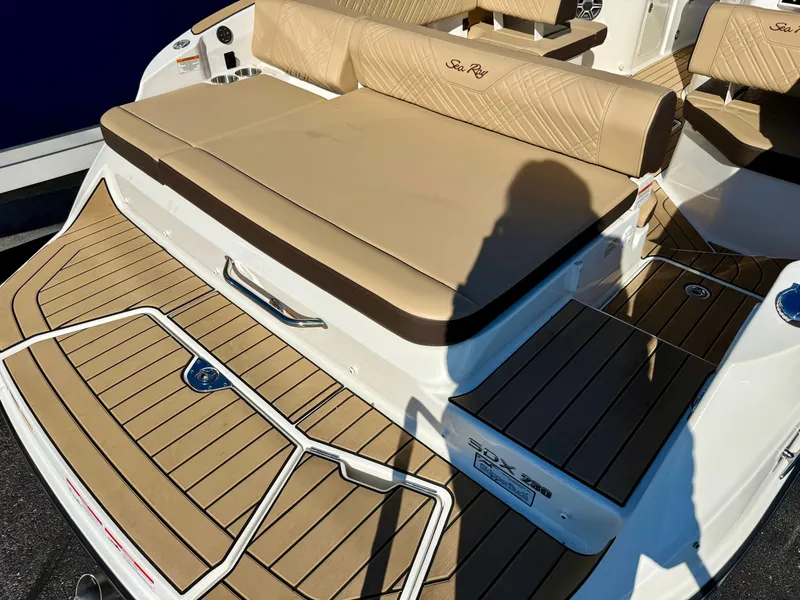 Slide: The Image of The image shows the rear of a Sea Ray SDX 230 boat with beige upholstery and teak flooring. - 3