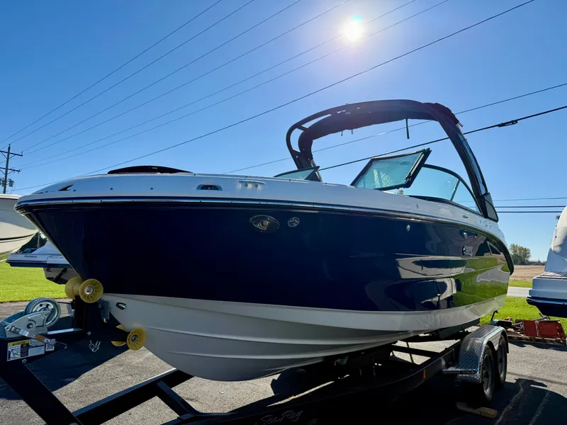 Slide: The Image of Sea Ray SDX 230 from 2026 on a trailer under a blue sky. - 1