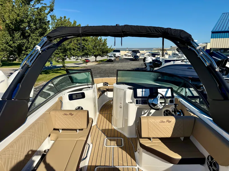 Slide: The Image of The image shows the cockpit of a Sea Ray SDX 230 boat with sleek seating and modern design. - 5