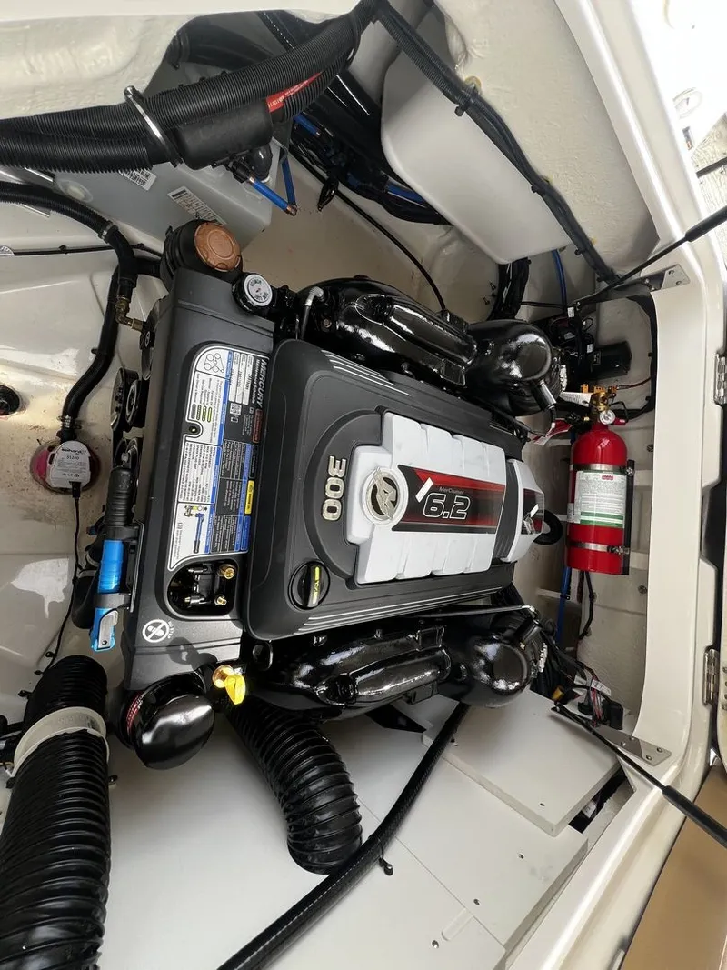 Slide: The Image of The engine compartment of a 2026 Sea Ray SDX 250 with a 6.2-liter engine and fire extinguisher. - 21