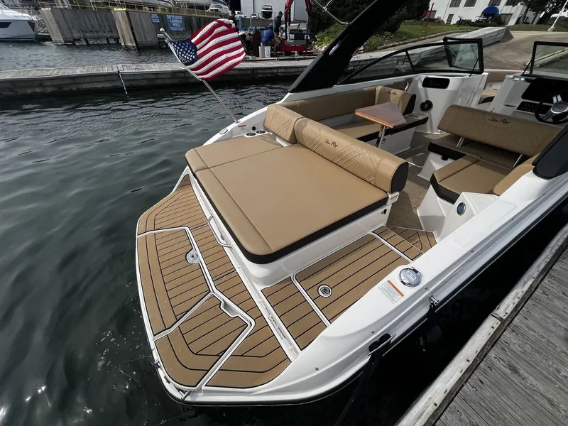 Slide: The Image of The image shows a 2026 Sea Ray SDX 250 boat with a spacious sun pad and an American flag at the stern. - 5