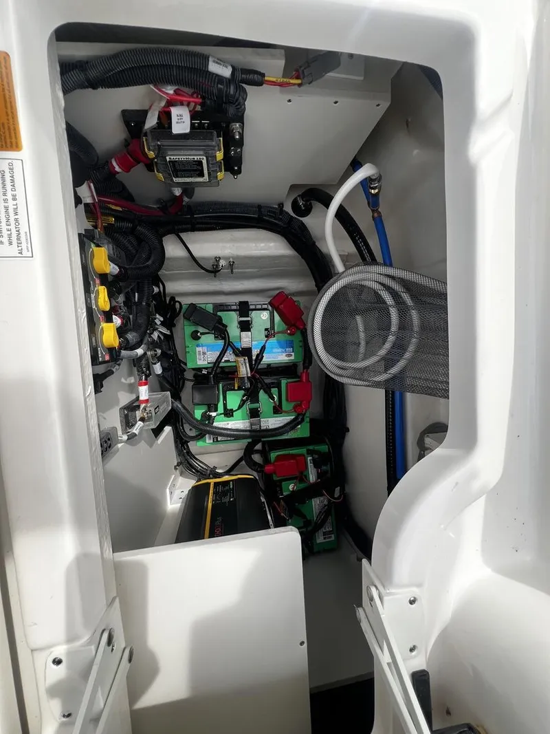 Slide: The Image of View of a Sea Ray SDX 250 engine compartment with batteries and wiring. - 22