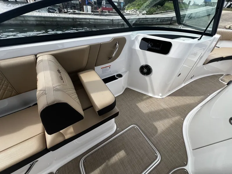 Slide: The Image of Interior of a 2026 Sea Ray SDX 250 with beige seating and sleek details. - 11