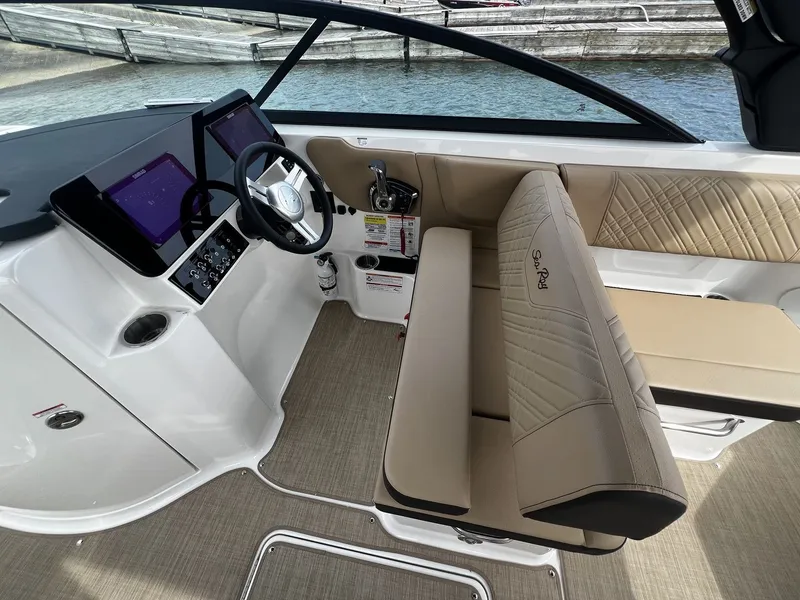 Slide: The Image of The image shows the cockpit of a 2026 Sea Ray SDX 250 with modern instruments and beige seating. - 9